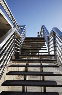 Low angle view of staircase against clear blue sky