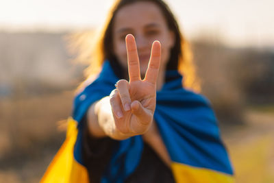 Cheerful ukrainian girl that shows a sign of peace or victory.