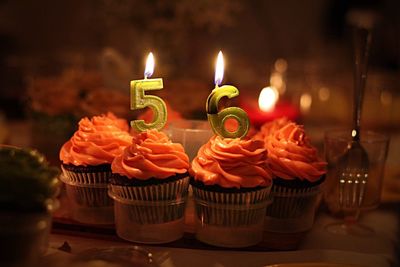 Lit birthday candles on cupcakes