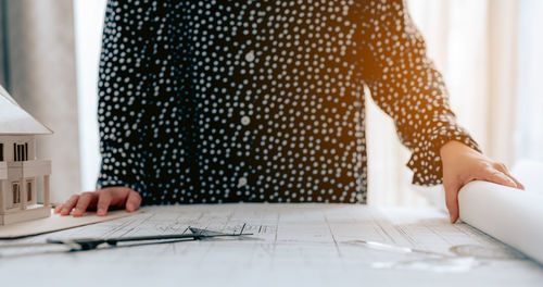 Midsection of woman working on table