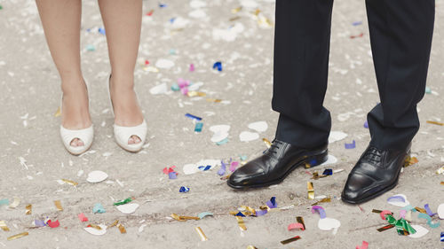 Low section of man and woman standing on street