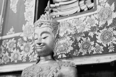 Low angle view of statue against temple building