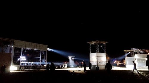 People in illuminated city at night
