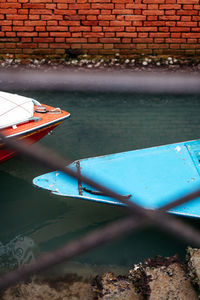 High angle view of boats in canal seen through window