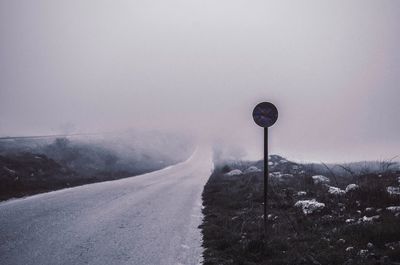 Empty country road in a foggy day