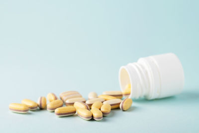 Medical pills or vitamins falling out of a medicine bottle. biologically active additives. 