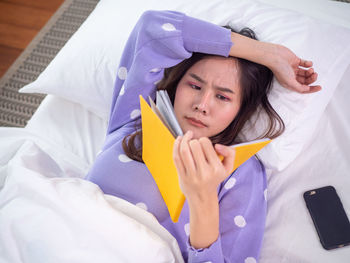 Portrait of woman lying on bed