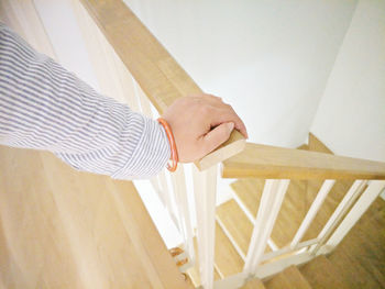 Cropped hand of woman on railing