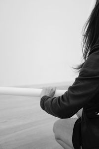 Close-up of woman standing against white background