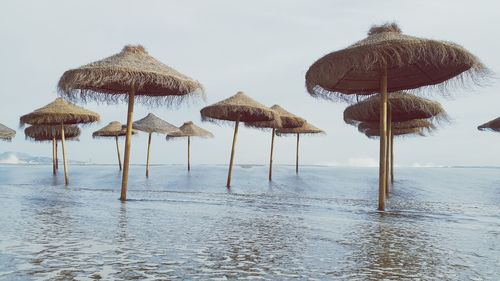 Umbrellas on beach against sky