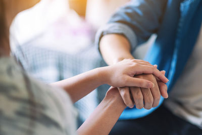 Close-up of business people holding hands