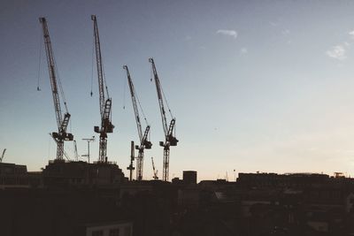 Low angle view of buildings against sky at sunset