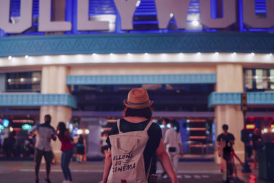 People walking in illuminated city at night