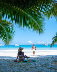 Rear view of woman standing at beach