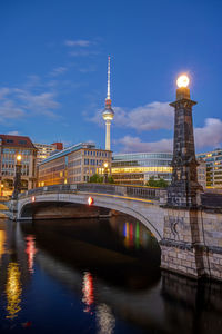 Historic bridge over the river spree in berlin at dawn with the television tower in the back