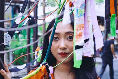 Portrait of young woman standing outdoors