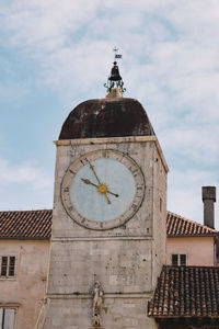 Low angle view of clock tower against sky