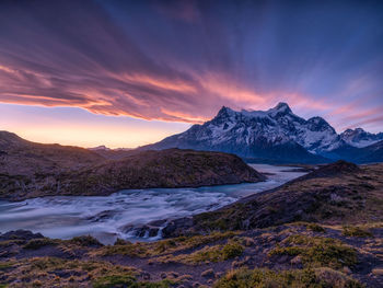 Scenic view of sea and mountains against sky during sunset