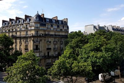 Trees and buildings against sky