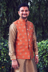 Portrait of smiling young man standing outdoors