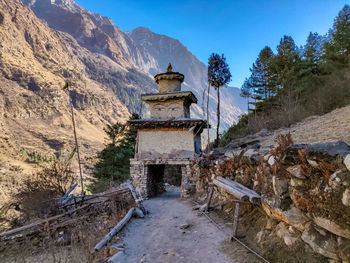 Built structure on mountain against sky