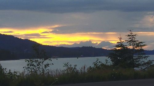 Scenic view of lake against cloudy sky