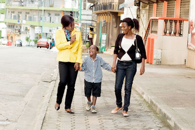 This family , together made a little walk in the street.