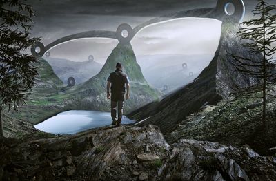 Digital composite image of man standing on rock against mountains