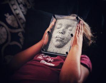 Midsection of woman holding camera