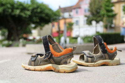 Close-up of shoes on street in city