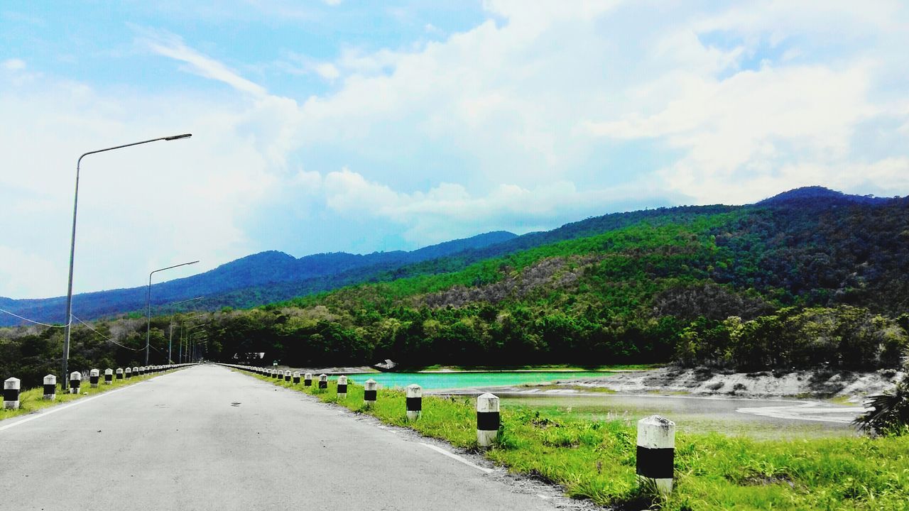 the way forward, sky, road, mountain, transportation, cloud - sky, diminishing perspective, grass, country road, vanishing point, mountain range, landscape, tree, empty, tranquility, tranquil scene, cloud, road marking, nature, scenics