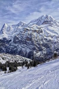 Scenic view of snowcapped mountains against sky