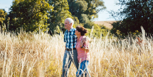 Senior couple walking in field