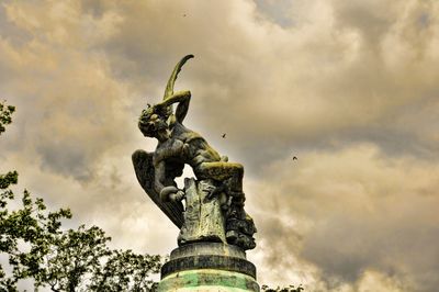 Low angle view of statue against cloudy sky