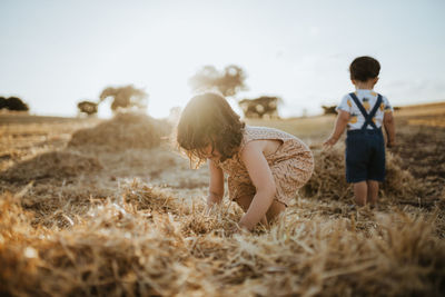 Brother and sister playing in the fields