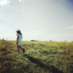 Woman on field against sky