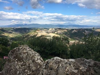 Scenic view of mountains against cloudy sky