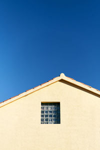 Low angle view of building against clear blue sky