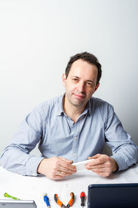 Portrait of a man sitting on table