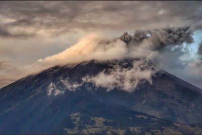 Scenic view of mountains against cloudy sky