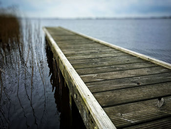 Pier over lake against sky