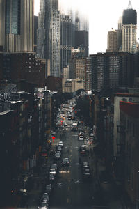 Cars on street amidst buildings in city