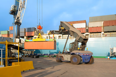 Containers being unloaded from a cargo ship at a port in chile.
