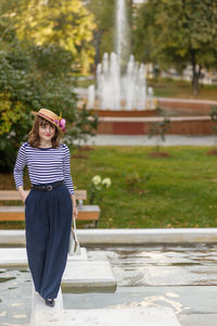 Rear view of woman standing in park