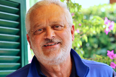 Portrait of smiling senior man standing outdoors