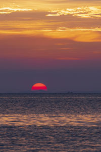 Scenic view of sea against romantic sky at sunset