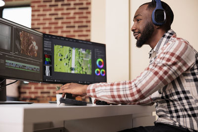 Side view of man working in office