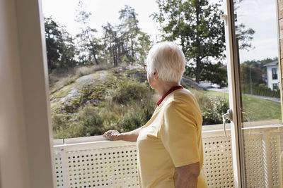 Woman on balcony looking away