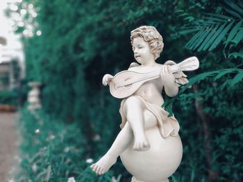 Close-up of angel statue in garden