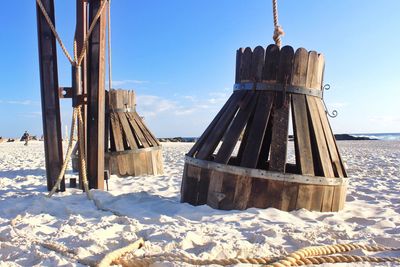 Wooden structures at beach against sky